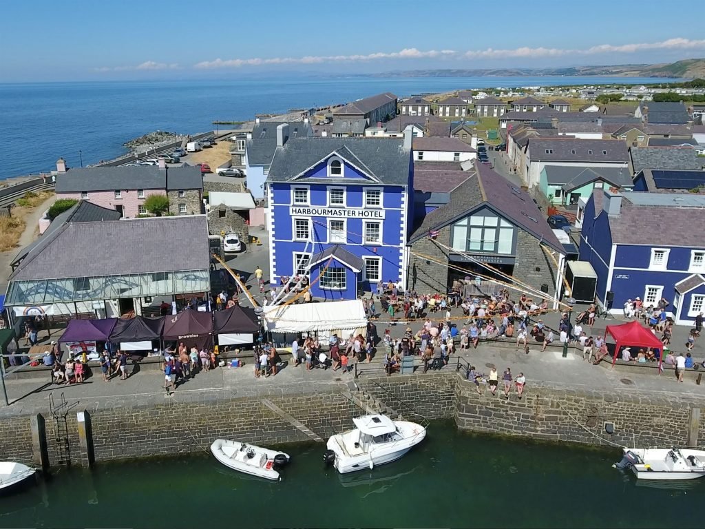 Visitors enjoying the waterfront at Aberaeron Harbour