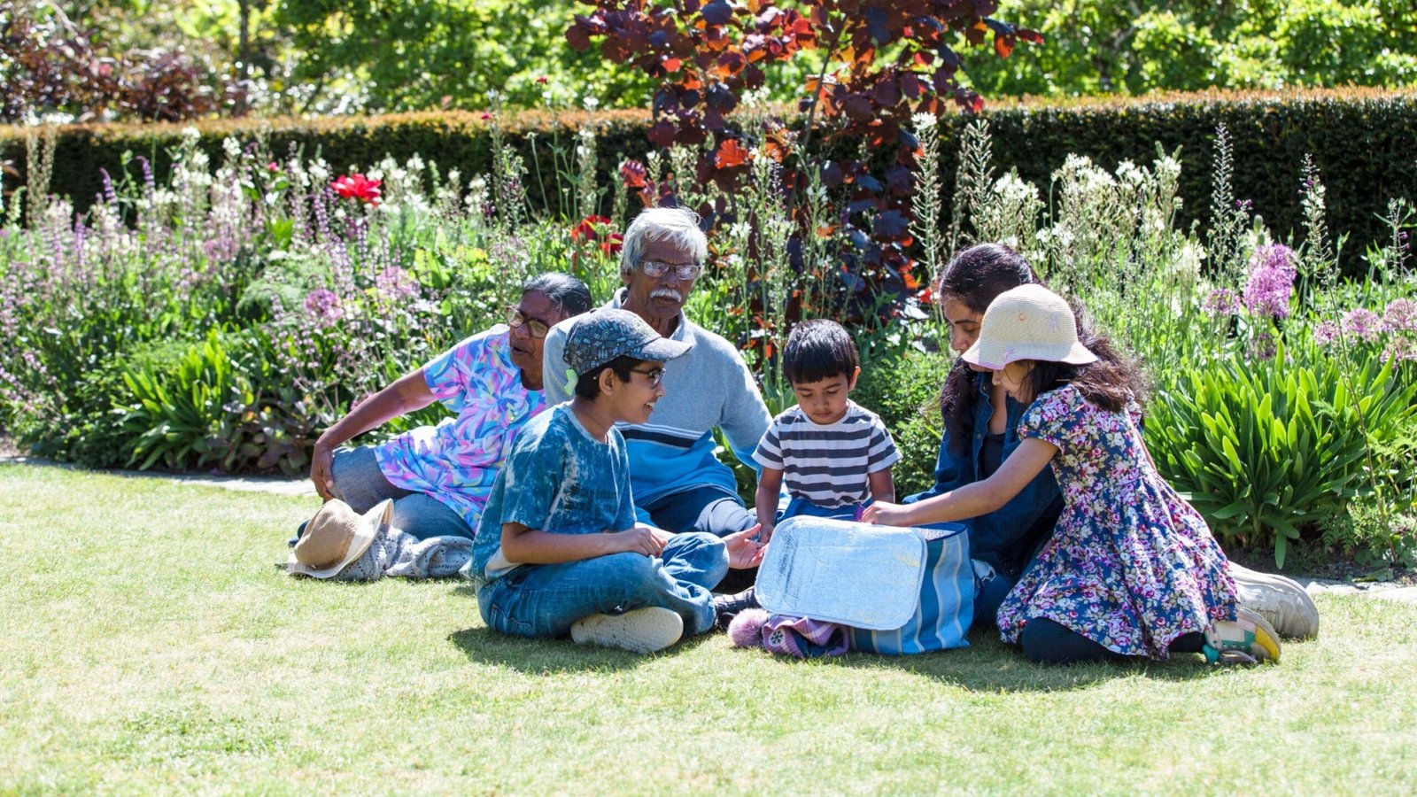 A family enjoying the gardens and open spaces at Bodnant Garden