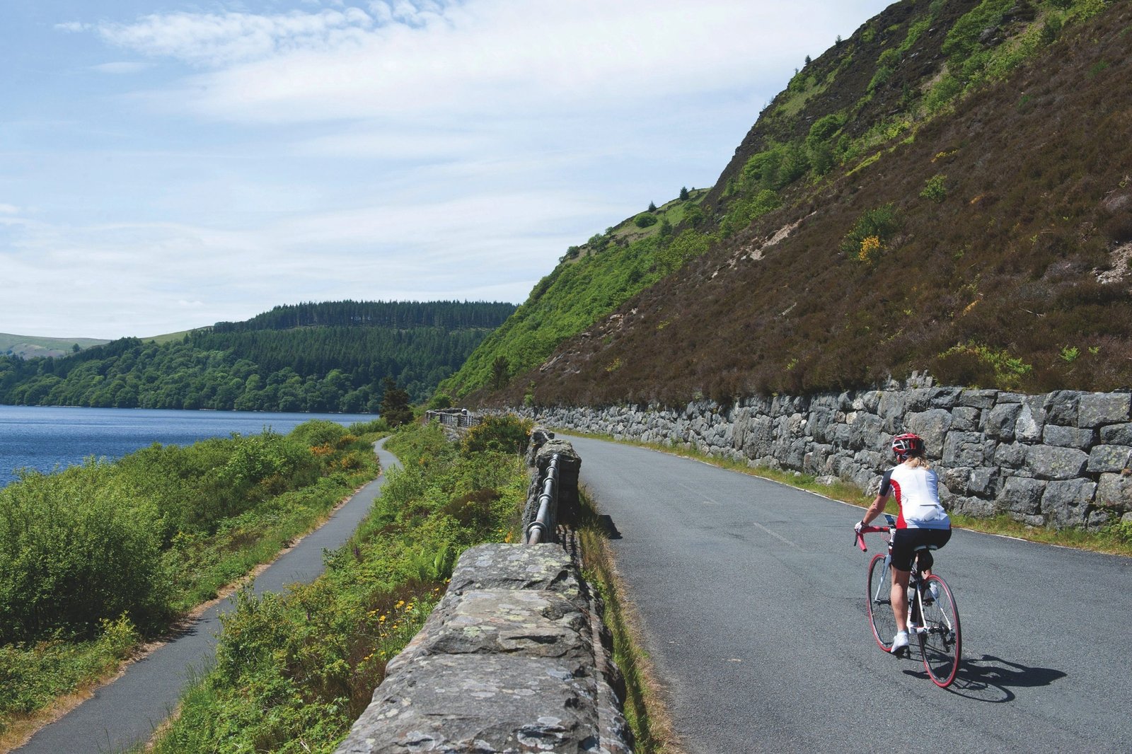 A scenic road beside the reservoirs and hills of the Elan Valley