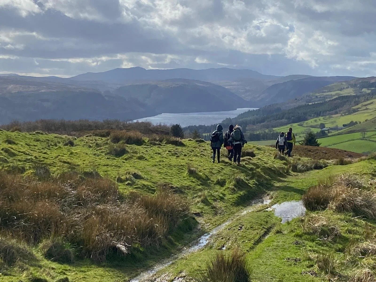 Visitors walking across Lake Vyrnwy Dam