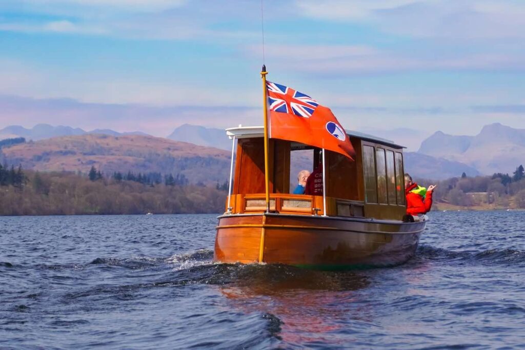 Lake Windermere panorama sailing boat mountains background Lake District scenery