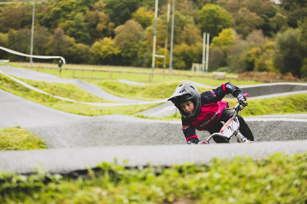Cyclist riding through a banked corner at Pump Track Wales